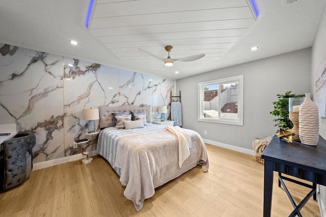 bedroom with baseboards, recessed lighting, light wood-style floors, and a ceiling fan