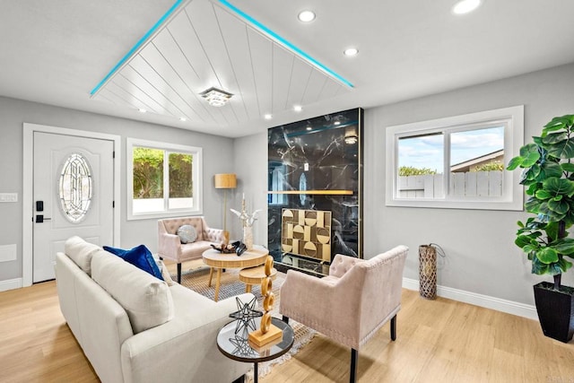 living room with light wood-style flooring, a healthy amount of sunlight, and recessed lighting