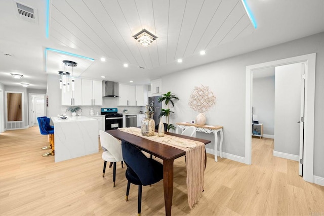 dining area with light wood-type flooring, recessed lighting, wooden ceiling, and visible vents