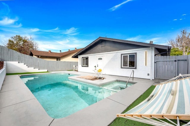 view of swimming pool featuring a jacuzzi, a fenced in pool, a fenced backyard, and a patio area