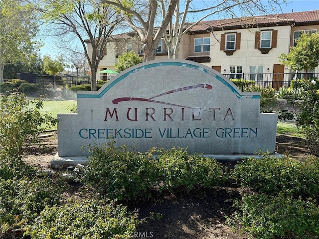 community sign featuring fence