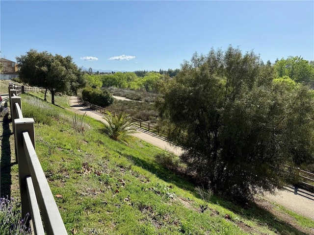 view of yard featuring a rural view and fence