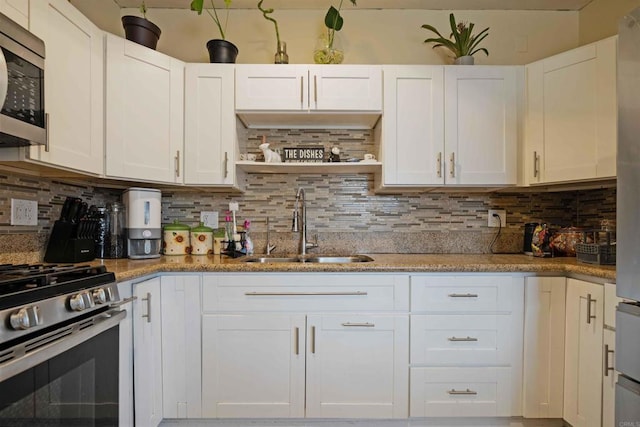 804 S 37th St, San Diego, CA 92113 - kitchen featuring a sink, stainless steel appliances, white cabinetry, tasteful backsplash, and open shelves
