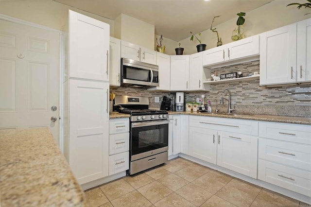 804 S 37th St, San Diego, CA 92113 - kitchen featuring stainless steel appliances, tasteful backsplash, and white cabinetry