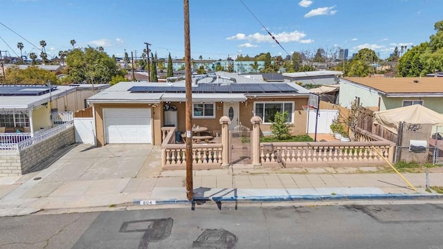 804 S 37th St, San Diego, CA 92113 - view of front of property with an attached garage, a fenced front yard, a gate, and solar panels
