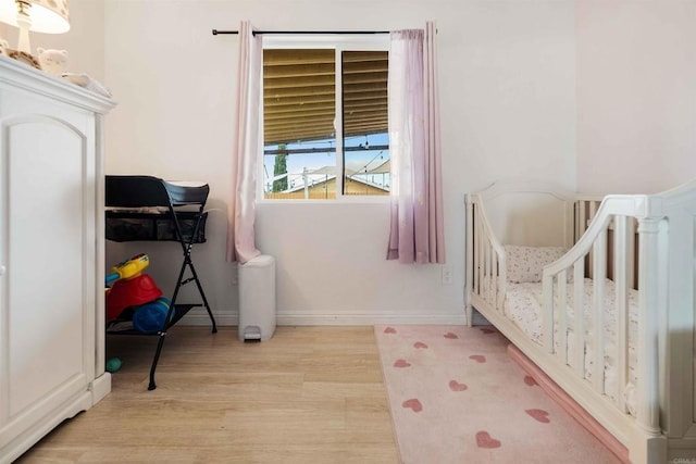 804 S 37th St, San Diego, CA 92113 - bedroom with light wood-type flooring, baseboards, and a nursery area