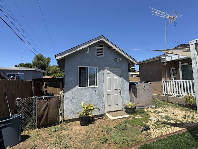 804 S 37th St, San Diego, CA 92113 - back of house with stucco siding, a pergola, and an outbuilding