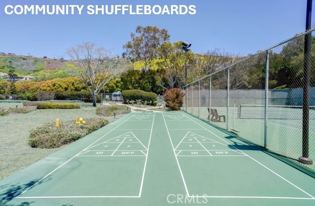 3200 La Rotonda Dr Unit 316, Rancho Palos Verdes, CA 90275 - view of home's community featuring shuffleboard, a tennis court, and fence