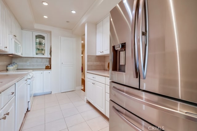 3200 La Rotonda Dr Unit 316, Rancho Palos Verdes, CA 90275 - kitchen featuring a raised ceiling, light countertops, white appliances, white cabinetry, and decorative backsplash