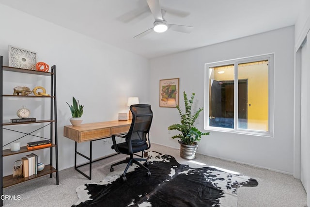 carpeted home office with ceiling fan