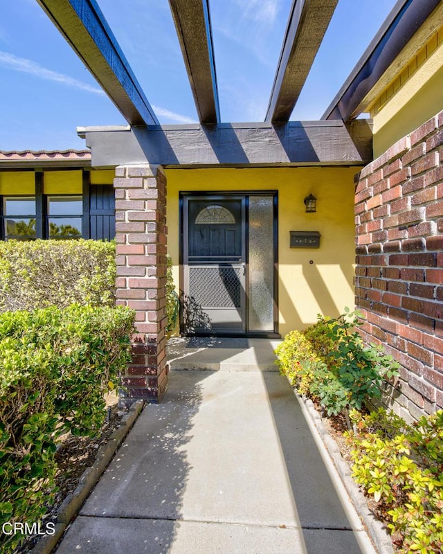 property entrance with brick siding