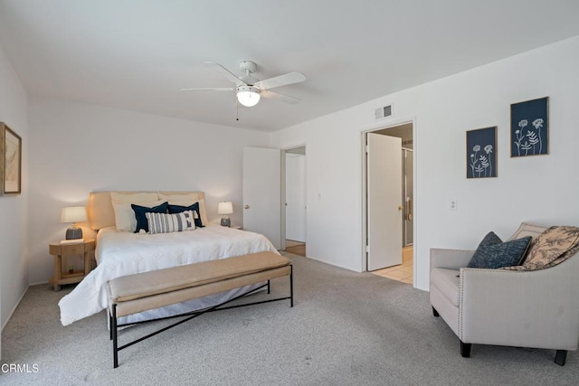 bedroom with ceiling fan, visible vents, and light colored carpet