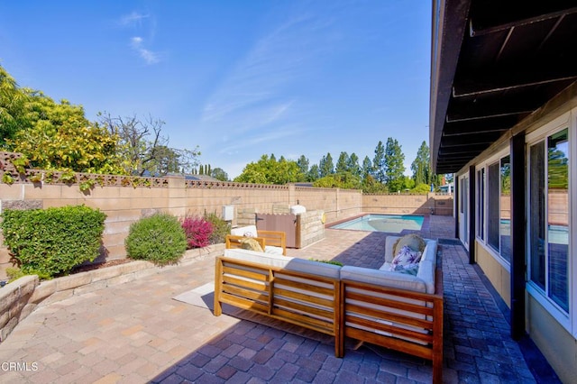 view of patio with a fenced backyard, a fenced in pool, and an outdoor living space