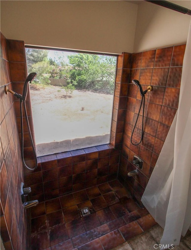 full bathroom featuring tiled shower
