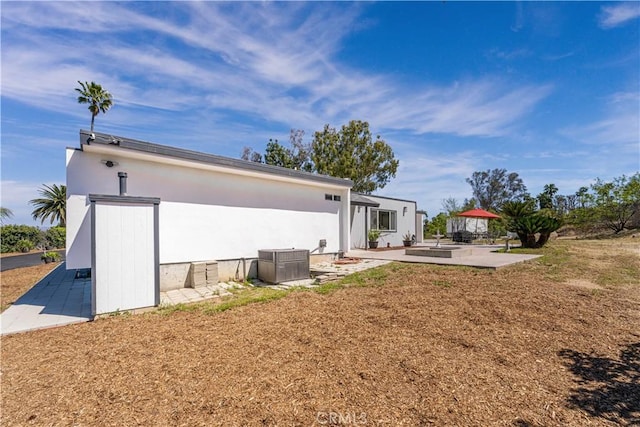 10220 Balmoral Ct, Riverside, CA 92503 - back of property with a patio area, stucco siding, and central AC unit