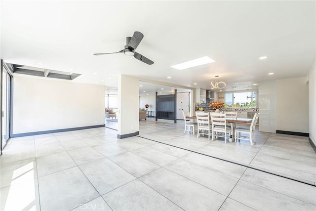 10220 Balmoral Ct, Riverside, CA 92503 - interior space with light tile patterned floors, a ceiling fan, recessed lighting, a skylight, and baseboards