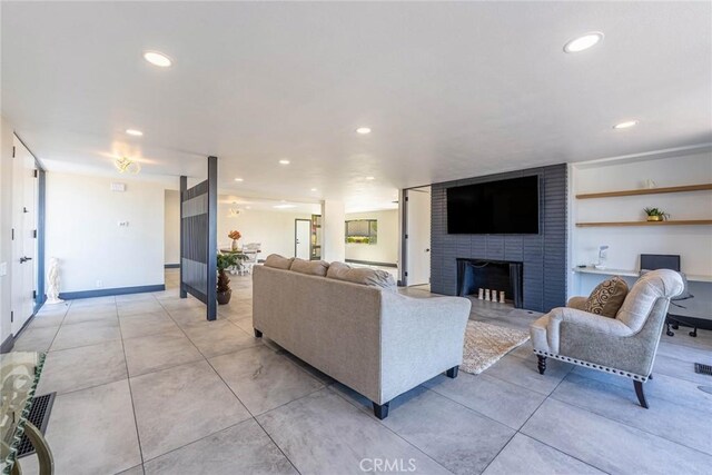 10220 Balmoral Ct, Riverside, CA 92503 - living area featuring recessed lighting, a fireplace, light tile patterned floors, and baseboards