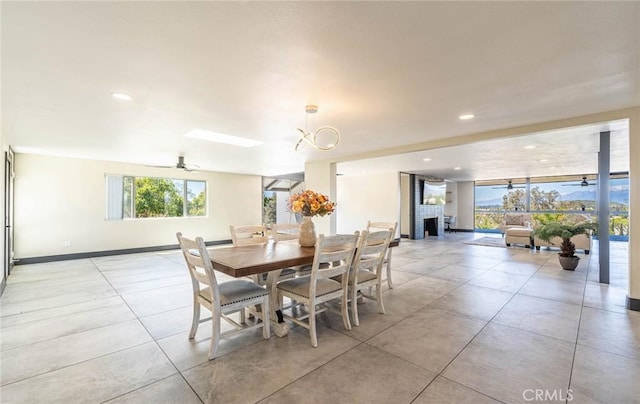10220 Balmoral Ct, Riverside, CA 92503 - dining space featuring ceiling fan with notable chandelier, a fireplace, baseboards, and recessed lighting