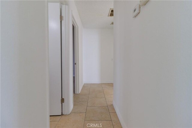 14256 Parkview Dr, Fontana, CA 92337 - hall featuring light tile patterned floors and baseboards