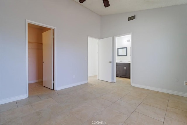 14256 Parkview Dr, Fontana, CA 92337 - unfurnished bedroom with a spacious closet, vaulted ceiling, a closet, baseboards, and ensuite bath