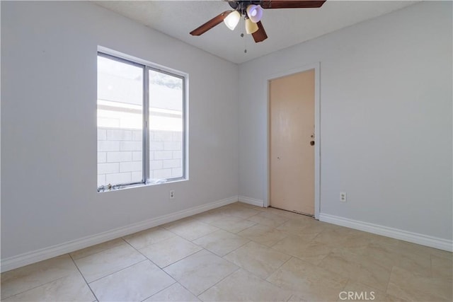 spare room with baseboards and a ceiling fan