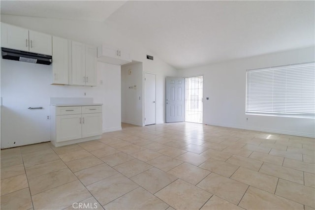 unfurnished living room with light tile patterned flooring, high vaulted ceiling, baseboards, and visible vents