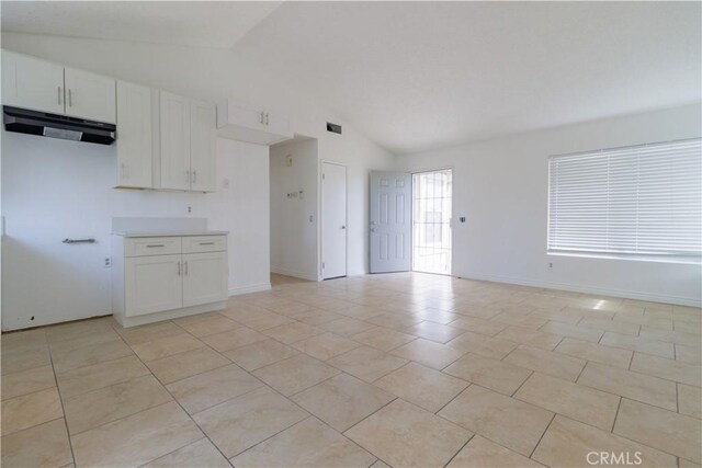 14256 Parkview Dr, Fontana, CA 92337 - kitchen with vaulted ceiling, exhaust hood, white cabinetry, baseboards, and light countertops