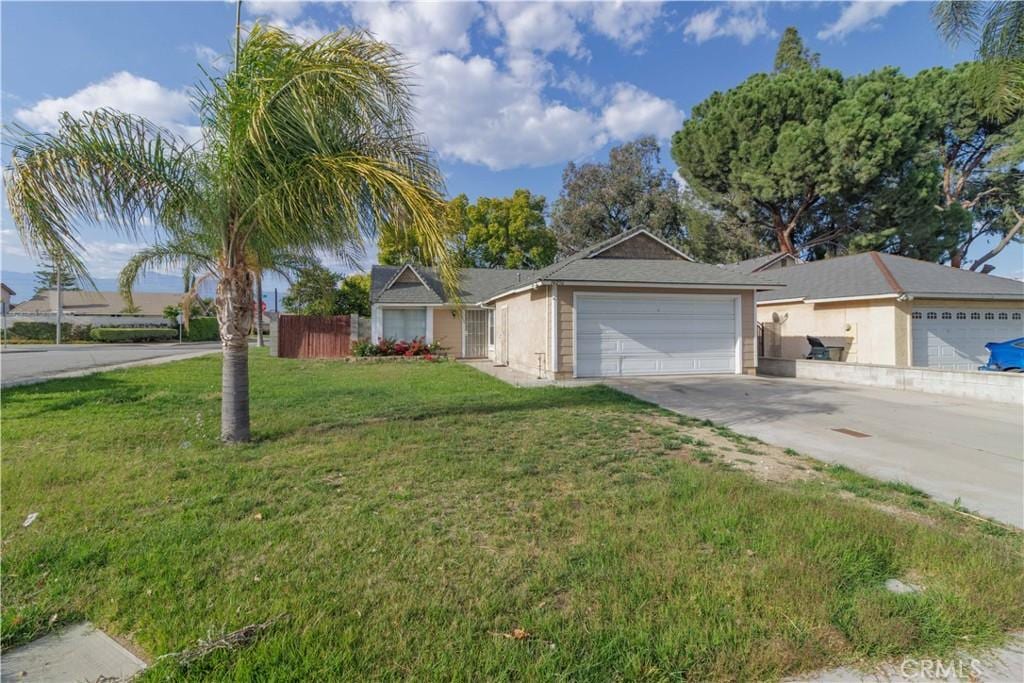 14256 Parkview Dr, Fontana, CA 92337 - ranch-style house with an attached garage and driveway