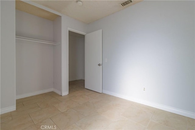 14256 Parkview Dr, Fontana, CA 92337 - unfurnished bedroom featuring a closet, baseboards, and light tile patterned floors