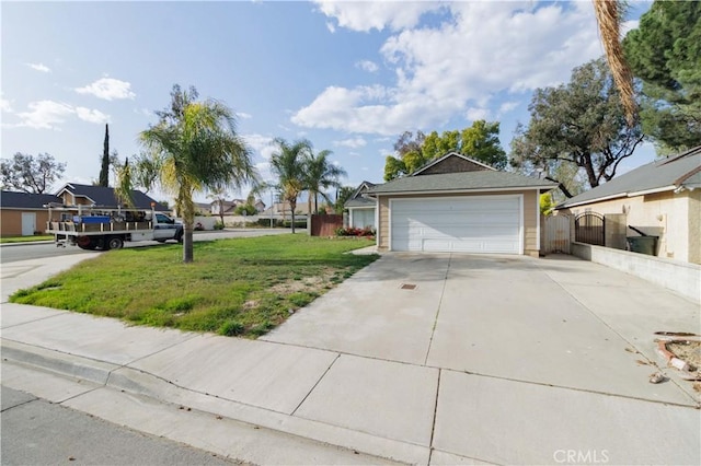 exterior space with driveway, a gate, and a front yard