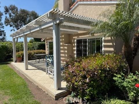 5219 Moya, Laguna Woods, CA 92637 - view of side of home with a pergola, a patio, a chimney, and stucco siding