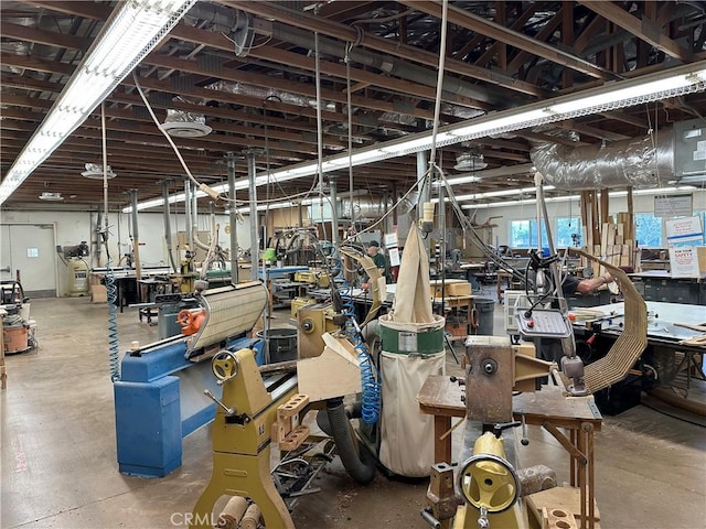 misc room with concrete floors and a workshop area