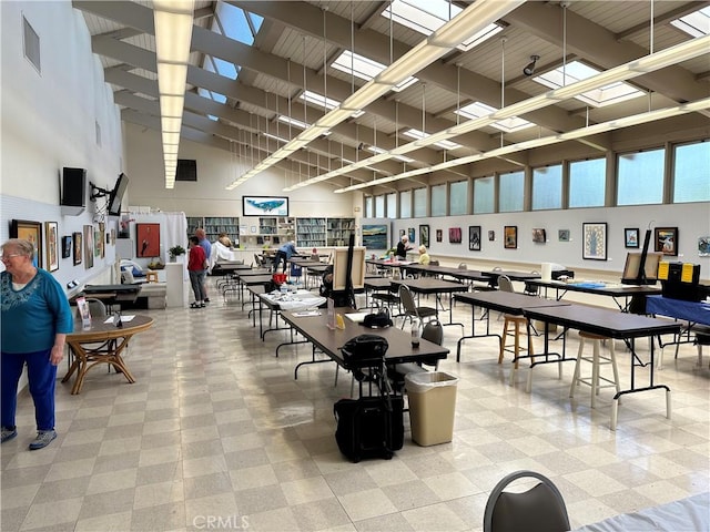 interior space featuring a high ceiling, tile patterned floors, and visible vents