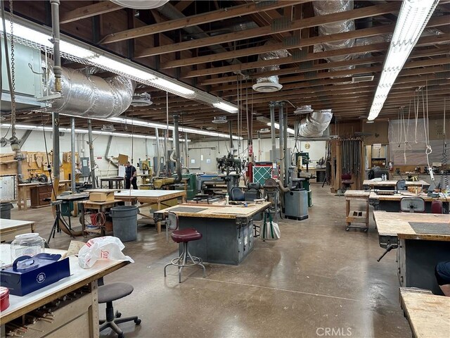 misc room featuring concrete floors and a workshop area