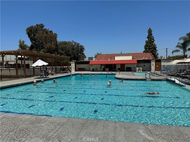 pool featuring a pergola, a patio, and fence