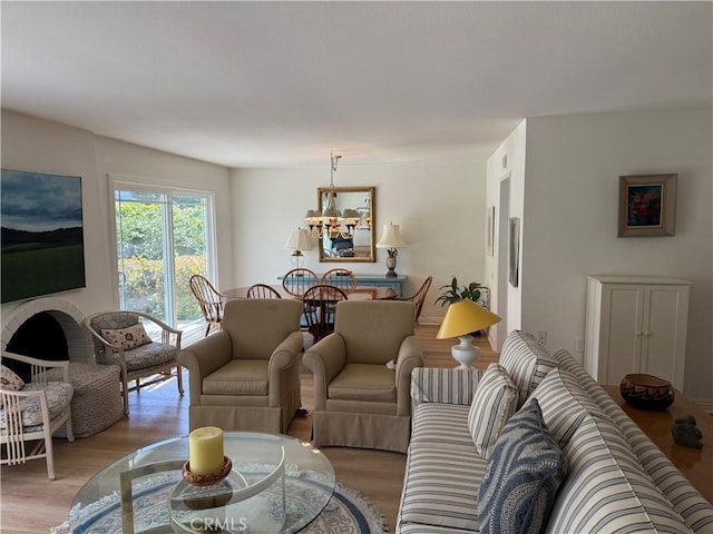 living room with a notable chandelier and light wood-style flooring