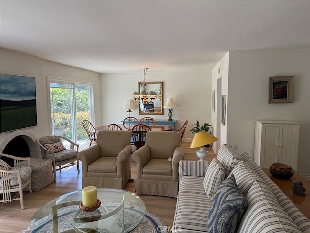 5219 Moya, Laguna Woods, CA 92637 - living room with light wood finished floors and a chandelier