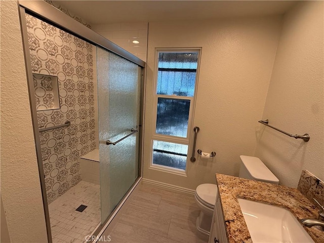 5219 Moya, Laguna Woods, CA 92637 - bathroom with vanity, a shower stall, healthy amount of natural light, and a textured wall
