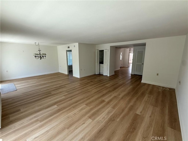 5219 Moya, Laguna Woods, CA 92637 - unfurnished room featuring a chandelier and light wood-type flooring