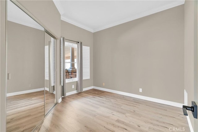 57 Plaza Brisas, San Juan Capistrano, CA 92675 - unfurnished bedroom with crown molding, wood finished floors, baseboards, and a closet
