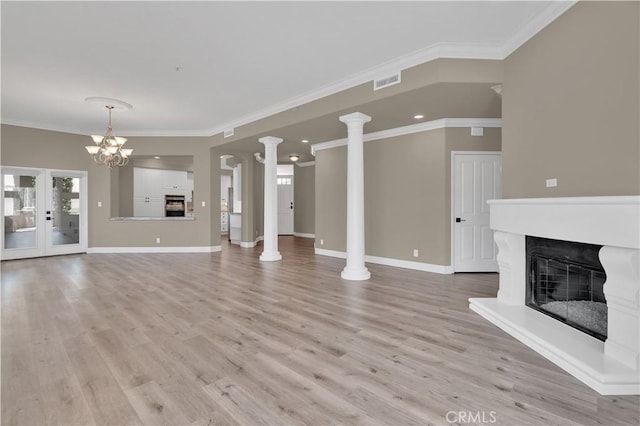 57 Plaza Brisas, San Juan Capistrano, CA 92675 - unfurnished living room featuring light wood-style flooring, ornamental molding, a glass covered fireplace, and visible vents