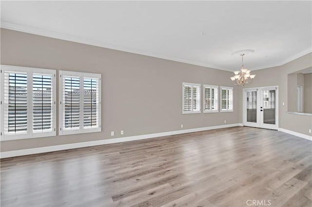 57 Plaza Brisas, San Juan Capistrano, CA 92675 - unfurnished living room with a chandelier, wood finished floors, ornamental molding, and a healthy amount of sunlight