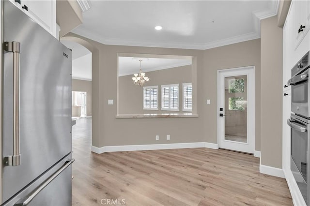 57 Plaza Brisas, San Juan Capistrano, CA 92675 - kitchen featuring light wood-style flooring, white cabinetry, appliances with stainless steel finishes, and ornamental molding