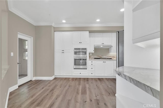 57 Plaza Brisas, San Juan Capistrano, CA 92675 - kitchen with light wood-style flooring, appliances with stainless steel finishes, ornamental molding, and under cabinet range hood