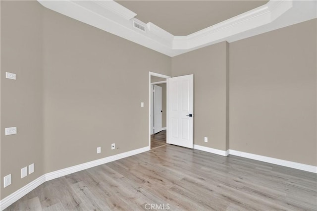 57 Plaza Brisas, San Juan Capistrano, CA 92675 - unfurnished room with baseboards, crown molding, visible vents, a raised ceiling, and wood finished floors