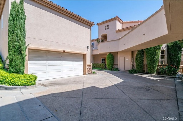 57 Plaza Brisas, San Juan Capistrano, CA 92675 - exterior space with a tiled roof, driveway, and stucco siding