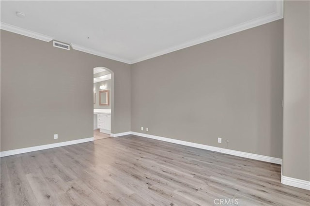 57 Plaza Brisas, San Juan Capistrano, CA 92675 - spare room featuring arched walkways, ornamental molding, visible vents, wood finished floors, and baseboards