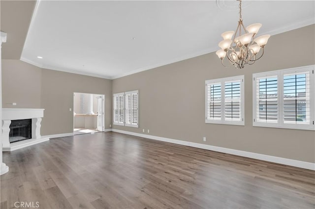 57 Plaza Brisas, San Juan Capistrano, CA 92675 - unfurnished living room with ornamental molding, an inviting chandelier, and wood finished floors