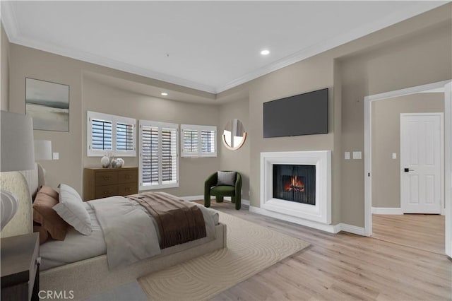 57 Plaza Brisas, San Juan Capistrano, CA 92675 - bedroom with crown molding, recessed lighting, a warm lit fireplace, and light wood-type flooring