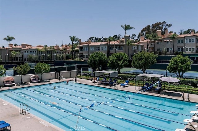 57 Plaza Brisas, San Juan Capistrano, CA 92675 - view of pool featuring a patio area, fence, and a residential view